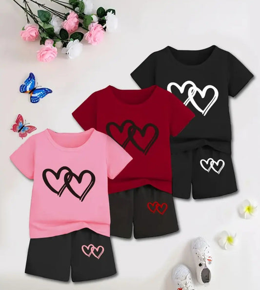 Girls' Summer Heart Outfit featuring a short sleeve T-shirt with a playful heart design and matching double heart print shorts in a vibrant color scheme, surrounded by decorative flowers and butterflies.